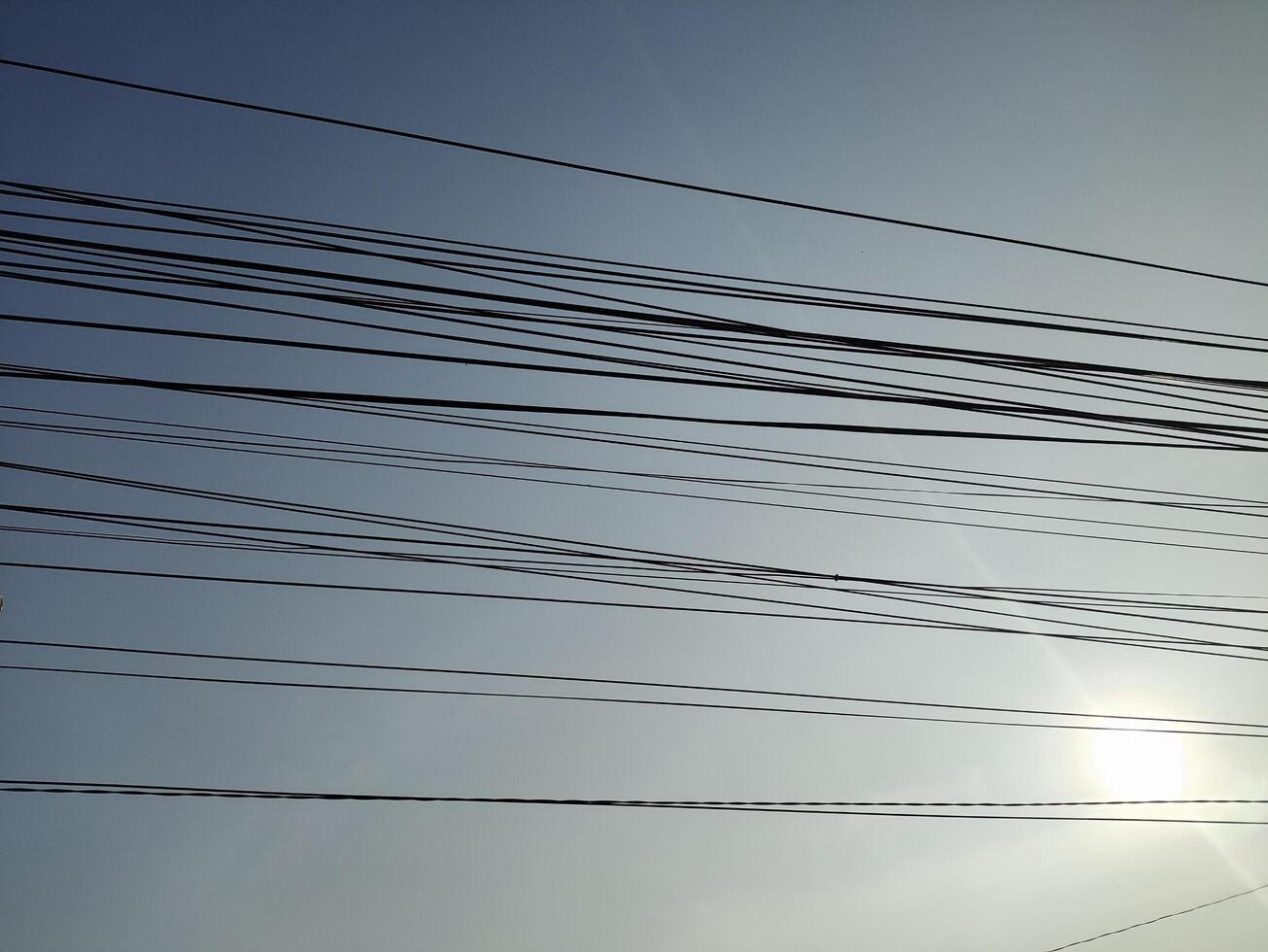 low angle view of cables against blue sky photo