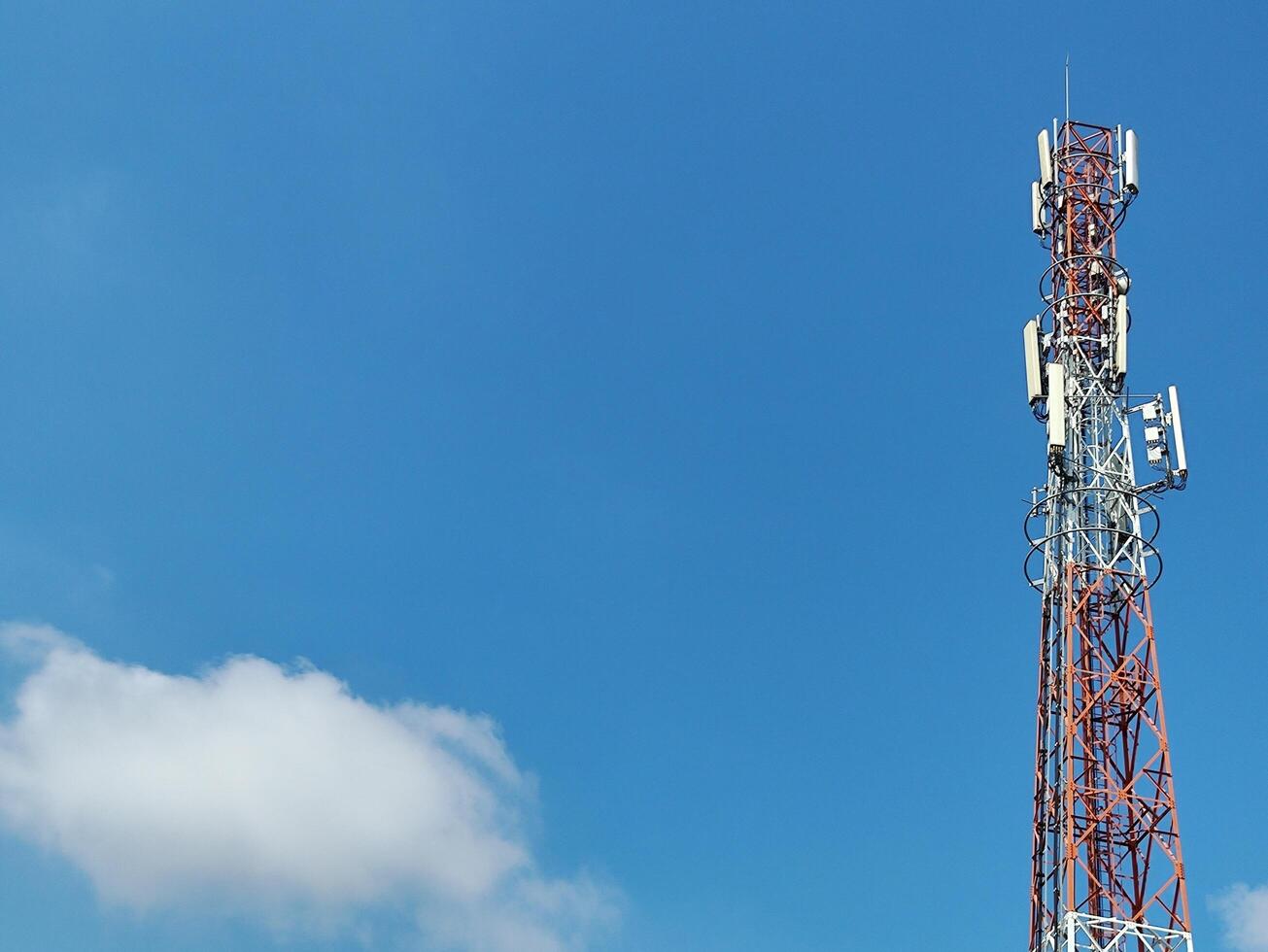 low angle view of communication tower against blue sky photo