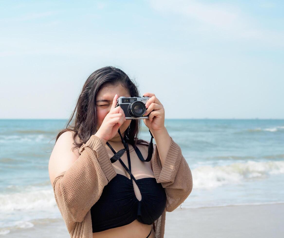 Portrait young asian woman fat chubby cute beautiful smile happy fun enjoy relax bikini swimwear body sexy front view sea beach white sand clean bluesky calm nature ocean wave water travel on holiday photo