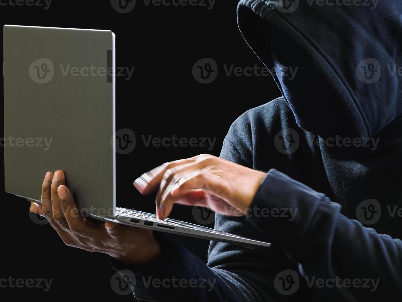 Hand hacker spy man one person in black hoodie sitting on table looking computer laptop used login password attack security to data digital internet network system night dark background copy space photo