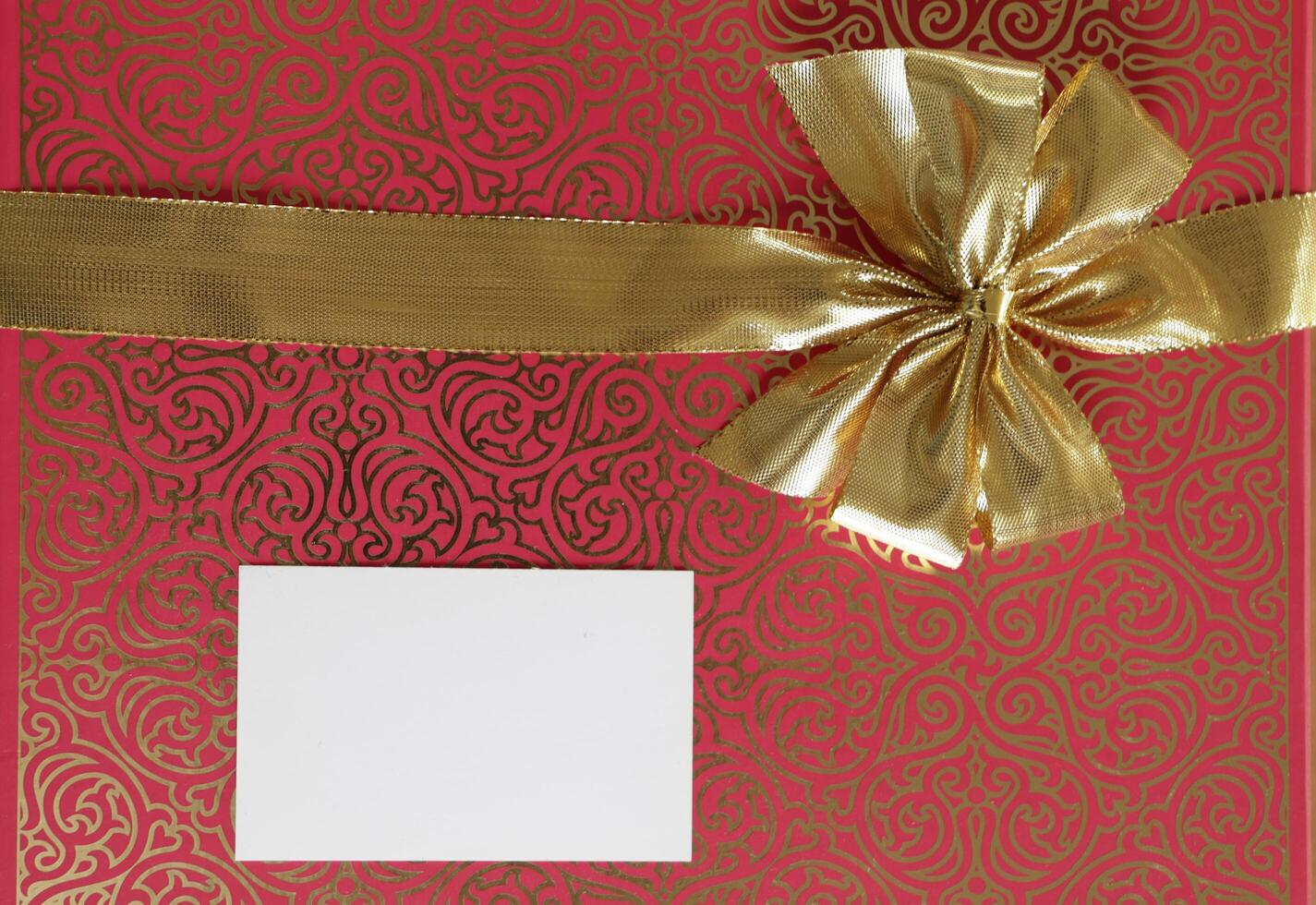 bow in a gold ribbon, valentines wishes, red background photo