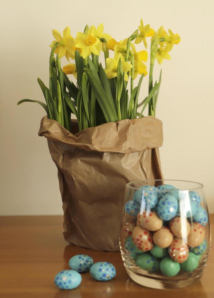 paper bag with daffodils and easter eggs photo