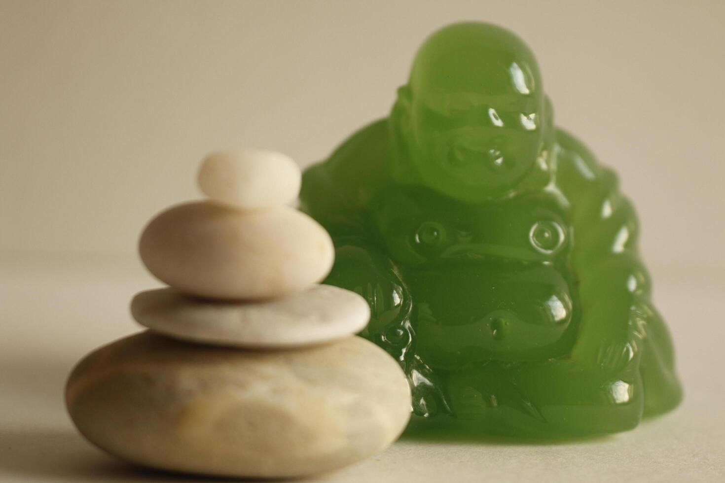 Buddha statue of jade, with piled pebbles photo
