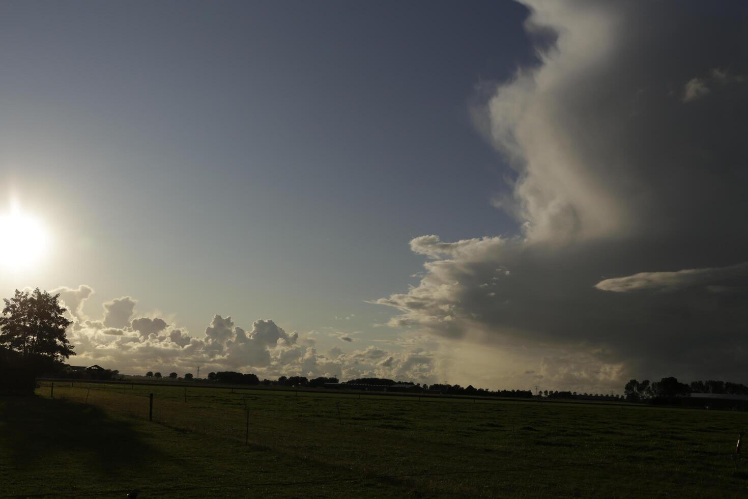 dramatic sky with thunder clouds in a dutch landscape photo