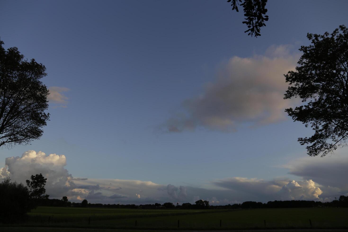 dramatic sky with thunder clouds in a dutch landscape photo