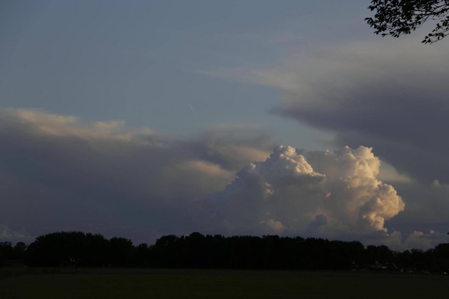 dramatic sky with thunder clouds in a dutch landscape photo