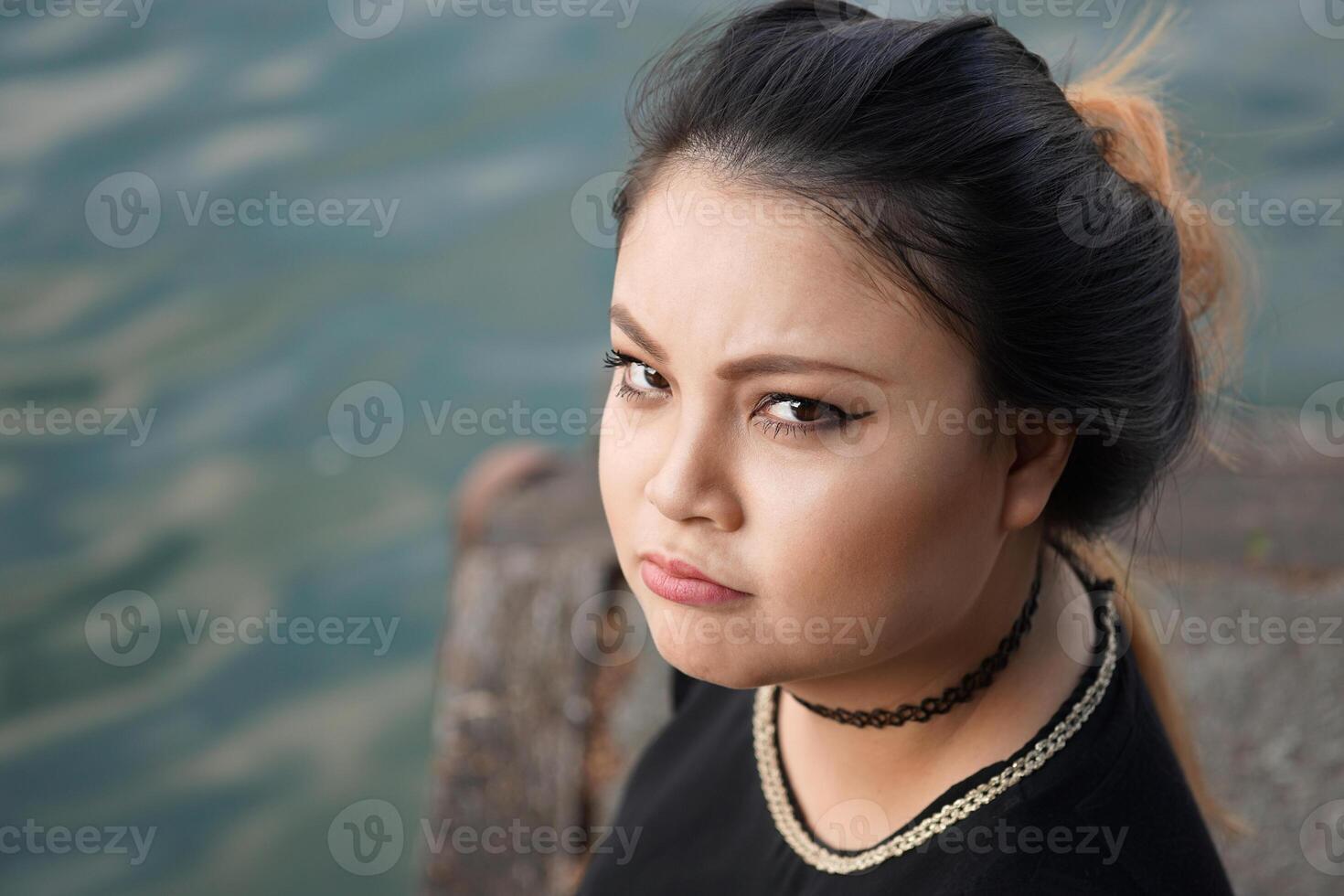grumpy young asian woman photo