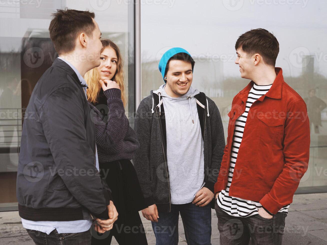 group of teenage friends talking laughing and having fun together photo