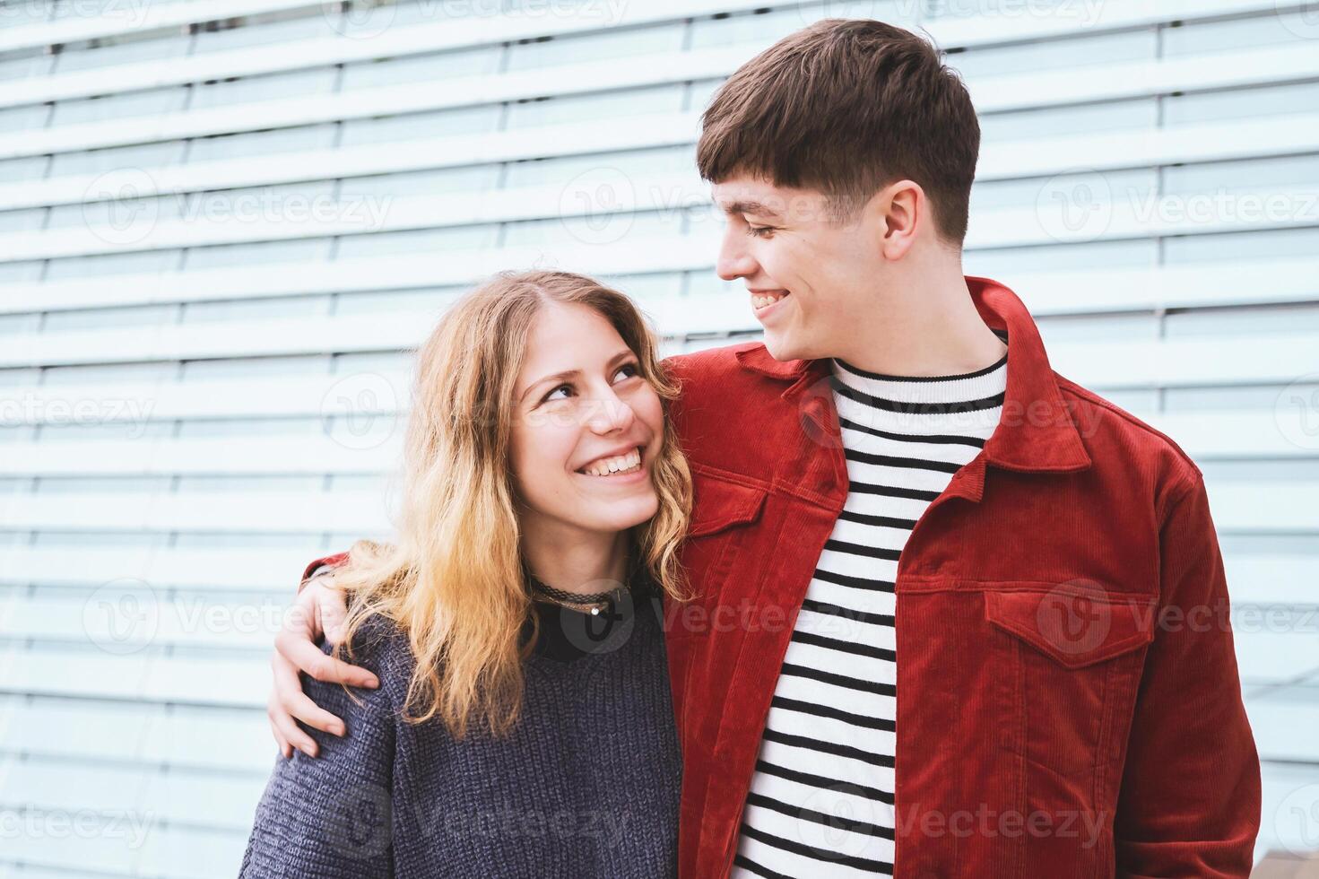 teenage couple in love looking into each others eyes photo