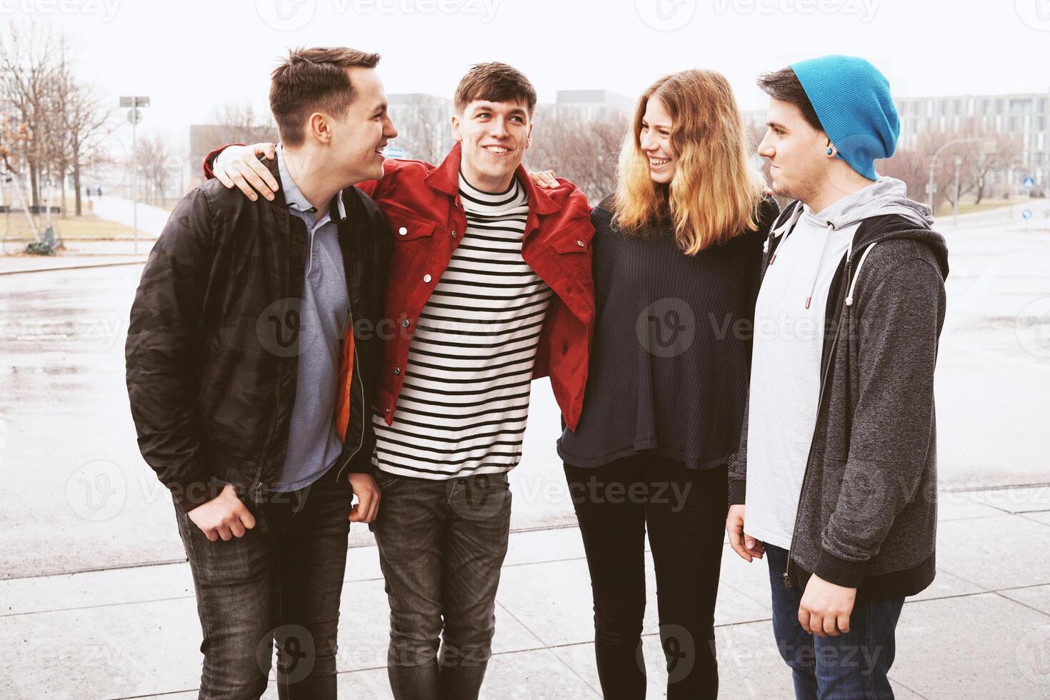 group of young urban friends having fun and laughing together photo