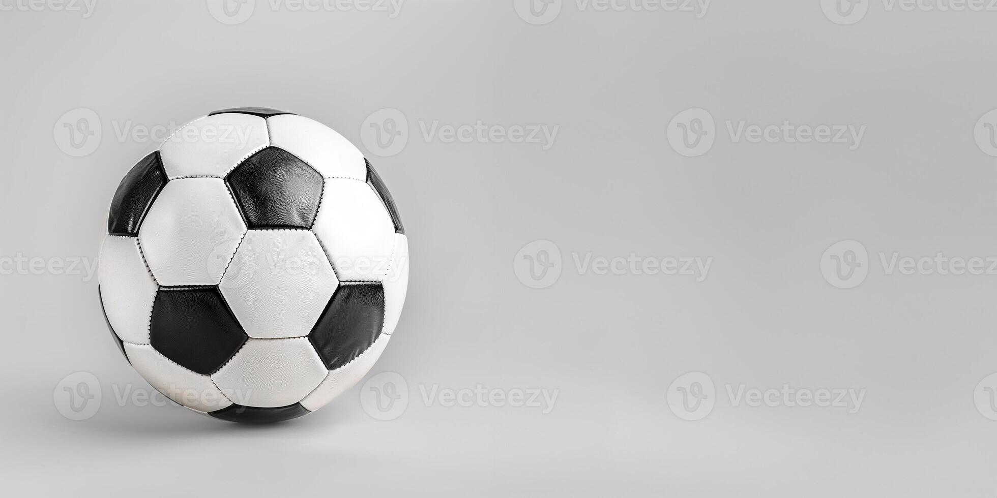 black and white soccer ball or football on gray background with copy space photo