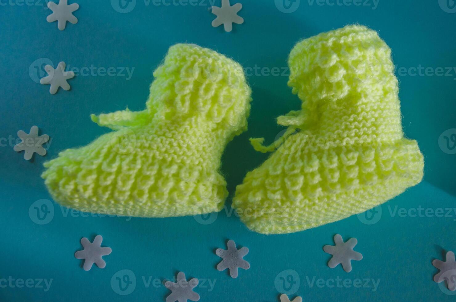 Knitted children's socks booties made of soft yellow thread photo