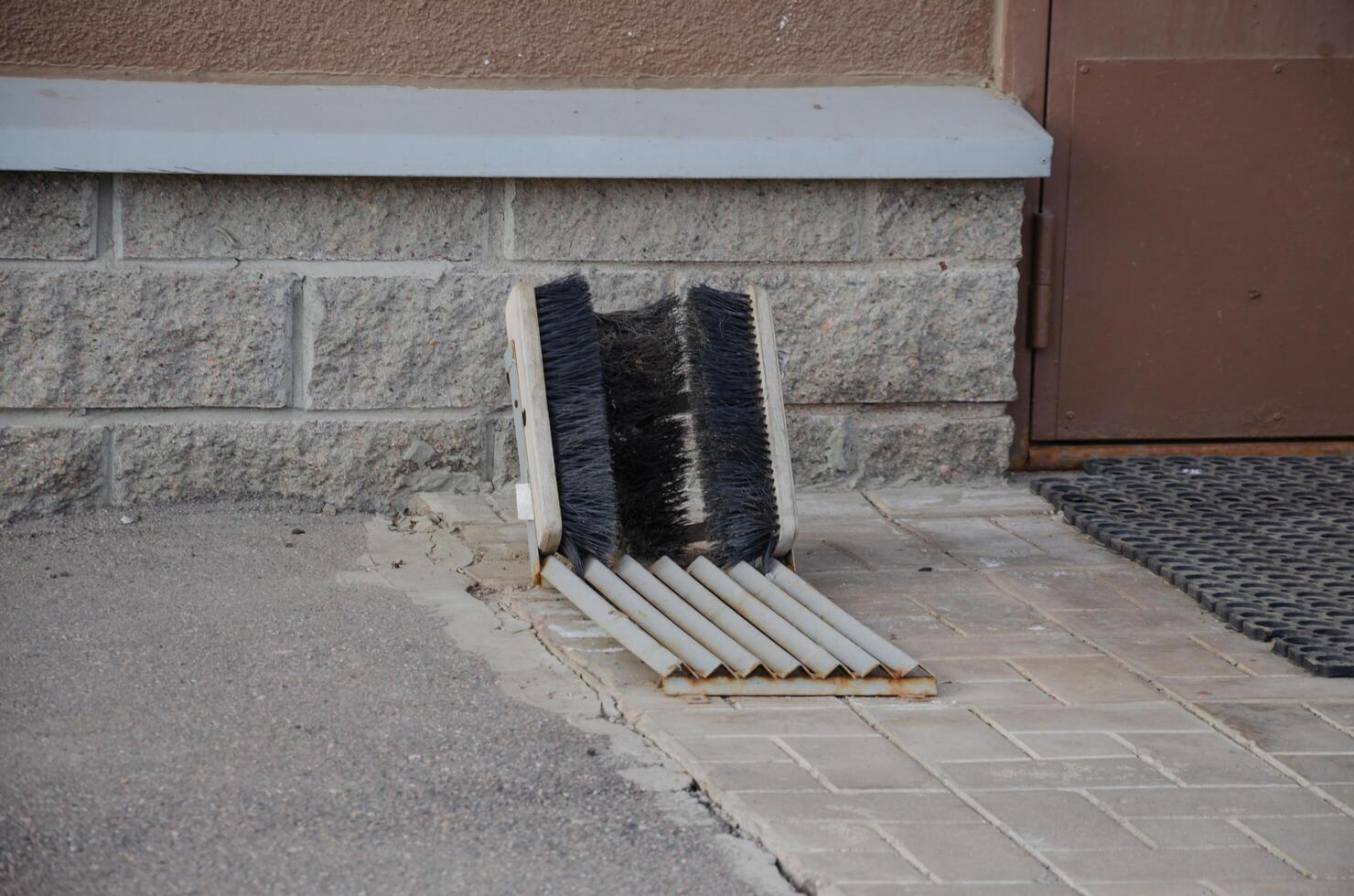 shoe brushes in front of the house on the street photo