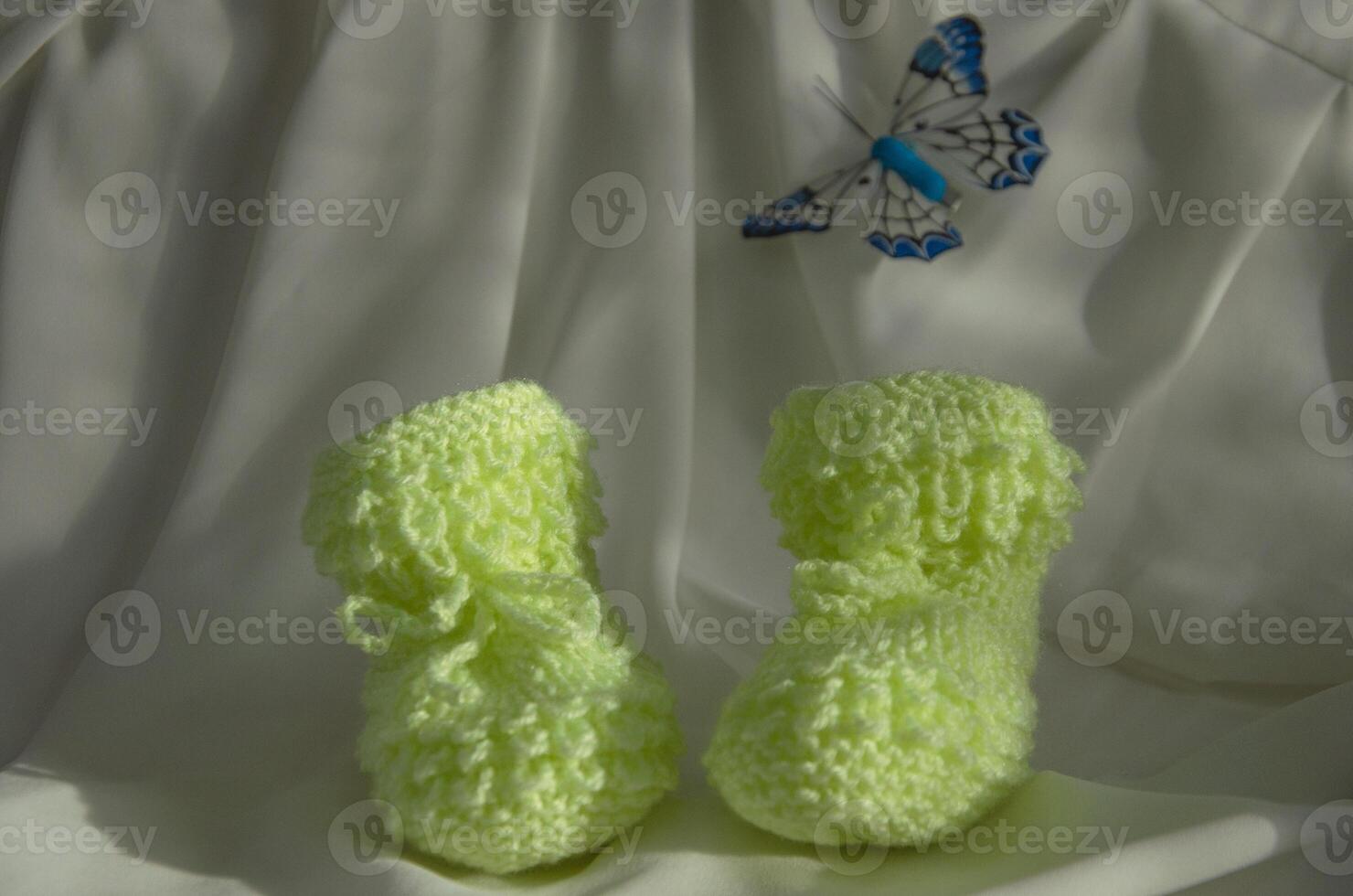 Knitted children's socks booties made of soft yellow thread photo