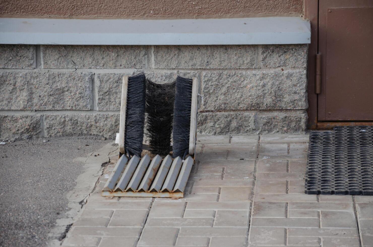 shoe brushes in front of the house on the street photo