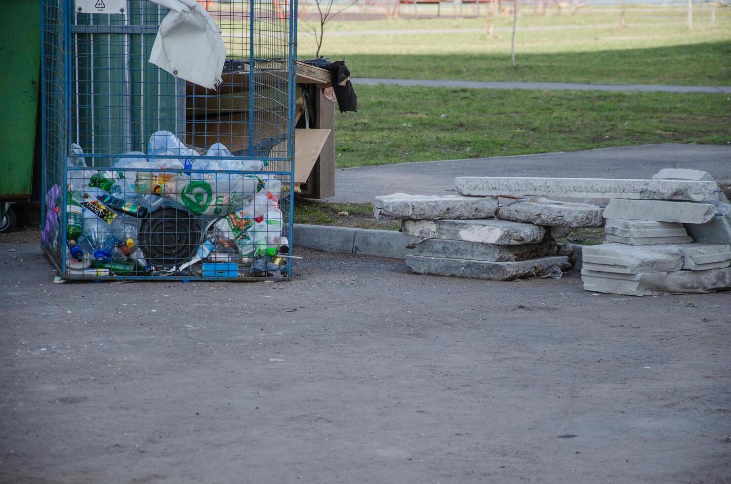 garbage containers with waste on the street photo