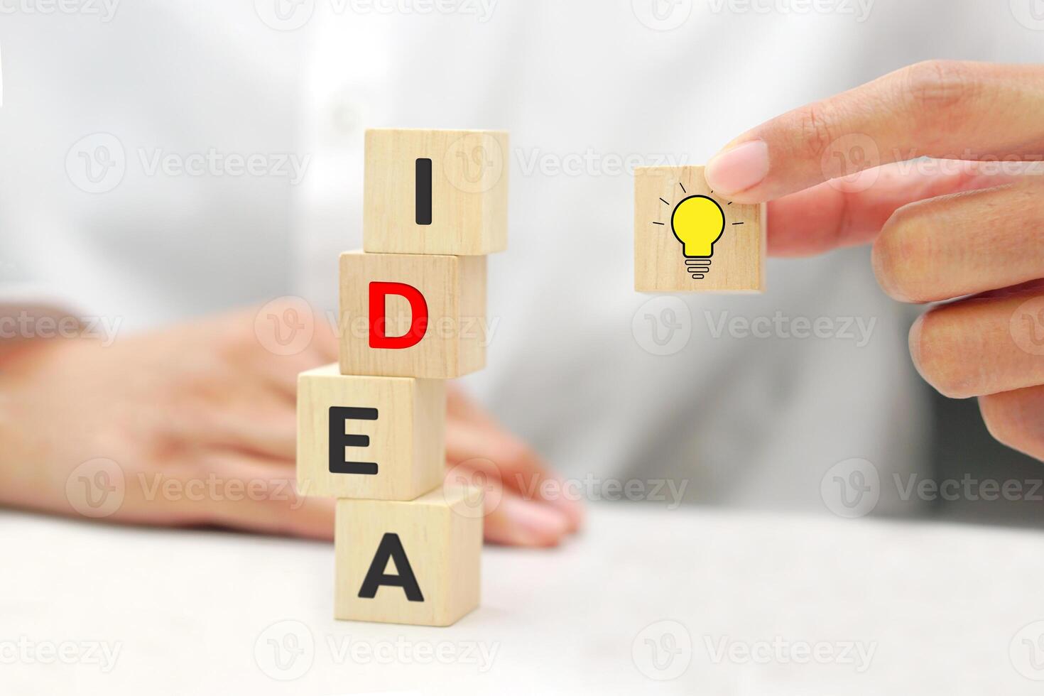 Hand holding a wooden block cube with light bulb icon symbol. Target of business and innovative idea concept. photo