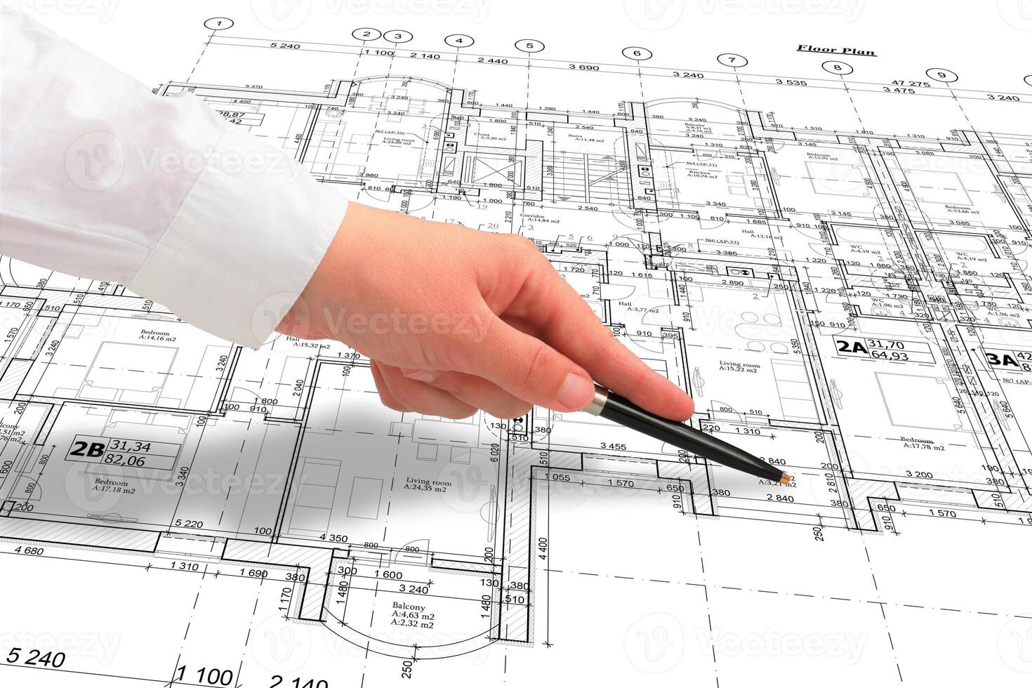 Woman architect in white shirt showing some details on the floor plan layout with a pen, close up of a hand photo