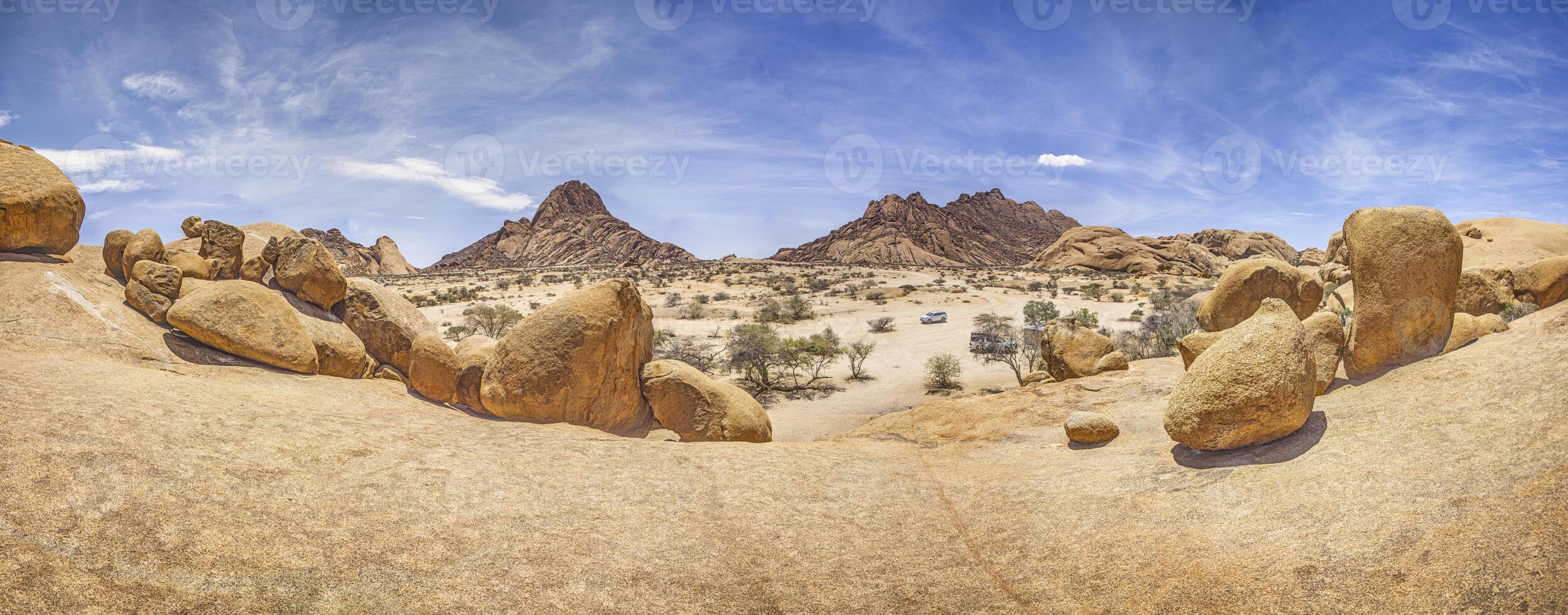 Panoramic picture of the Spitzkoppe in Namibia during the day against a blue sky photo