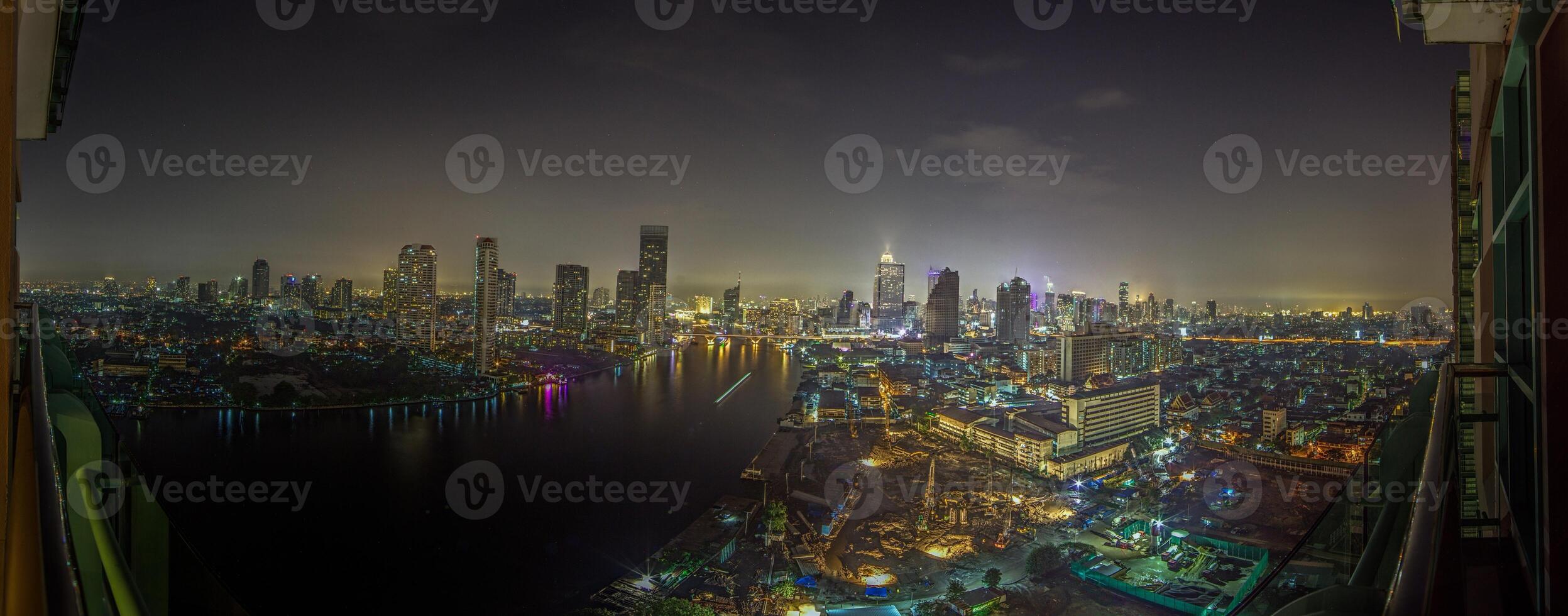 View over Bangkok at night with the Chao Phraya River photo