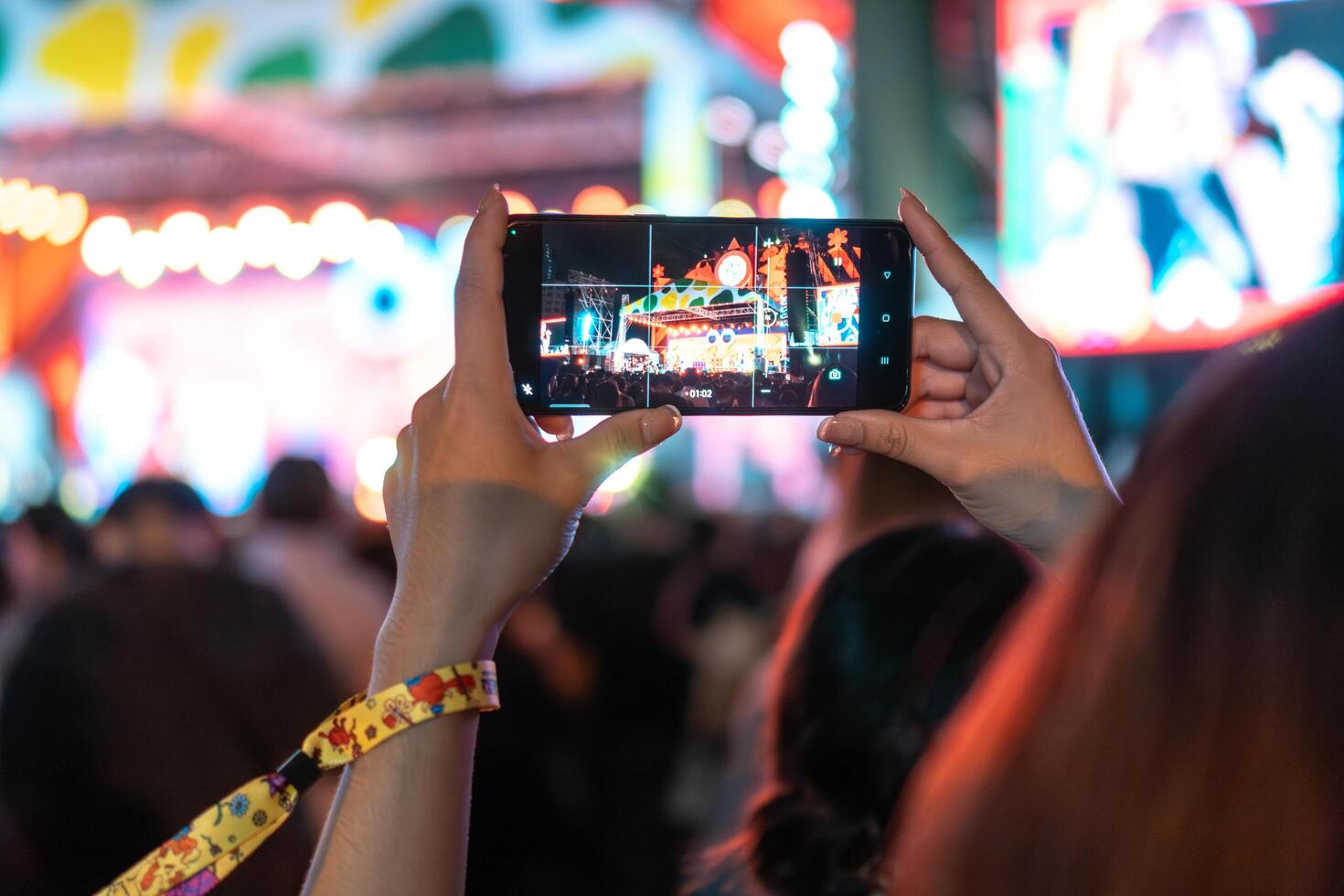 People holding smart phone and recording and photographing in music festival concert photo