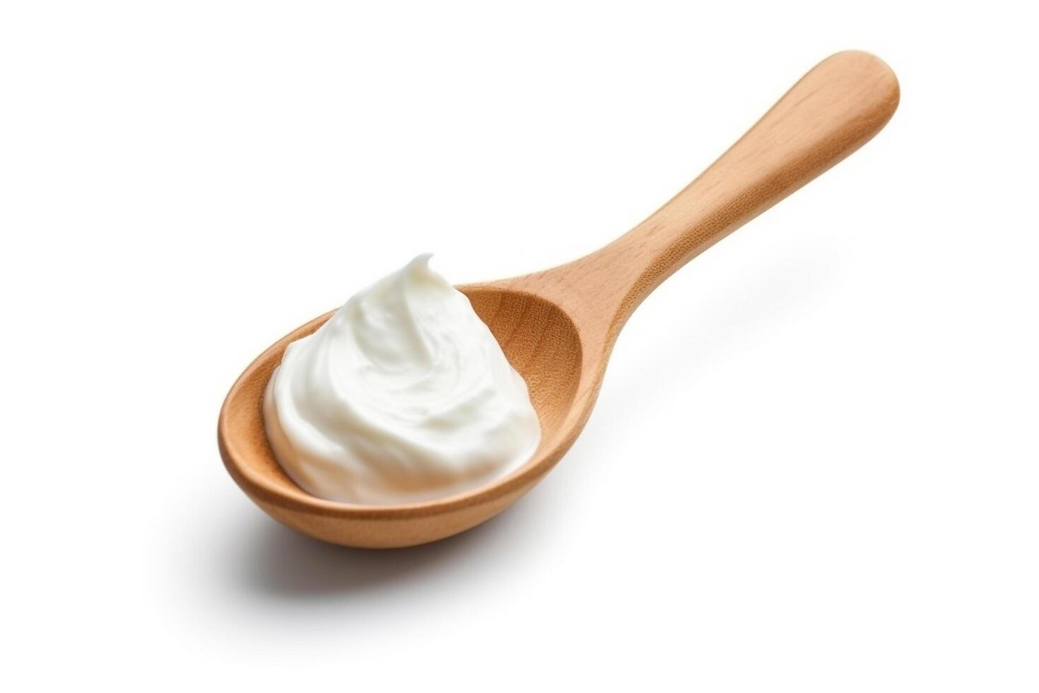 Sour cream in the wooden spoon isolated on white background.. photo