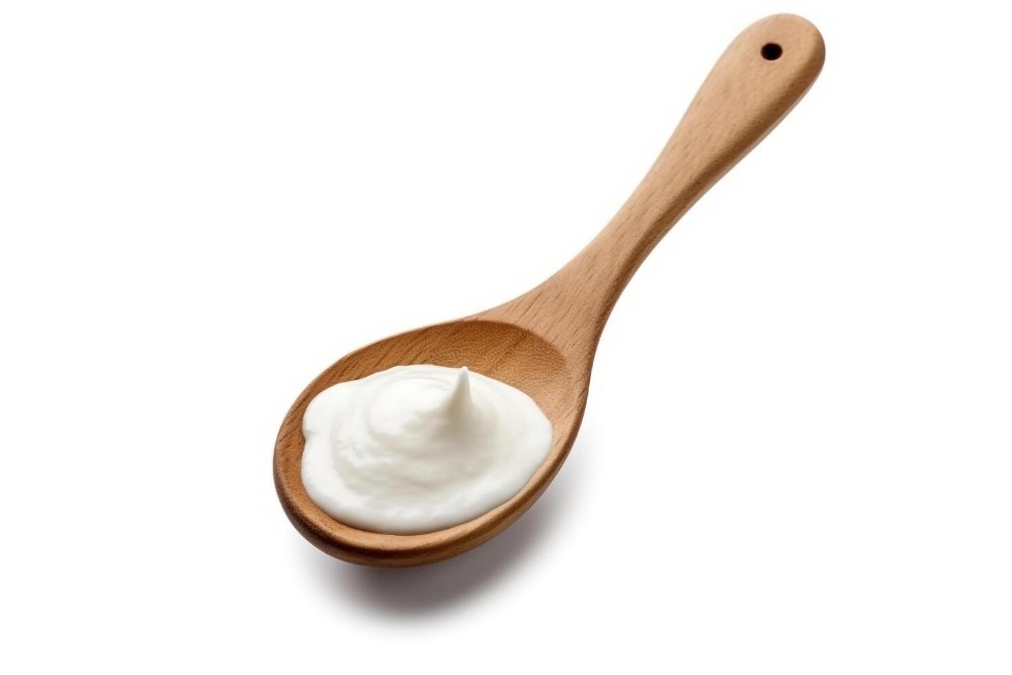 Sour cream in the wooden spoon isolated on white background.. photo