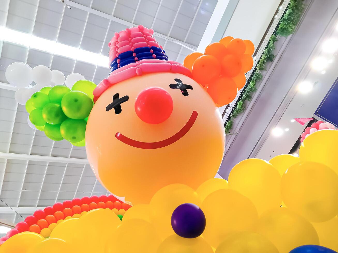 Low angle view of big colorful clown balloon doll in shopping mall area photo