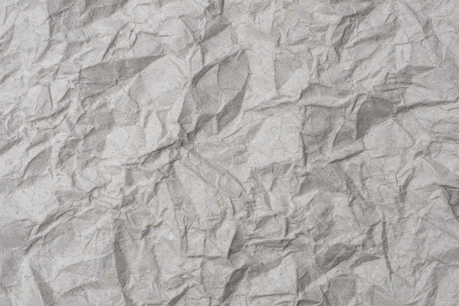 Gray crumpled KI kraft paper texture background. The old wrinkled craft paper backdrop for recycling photo