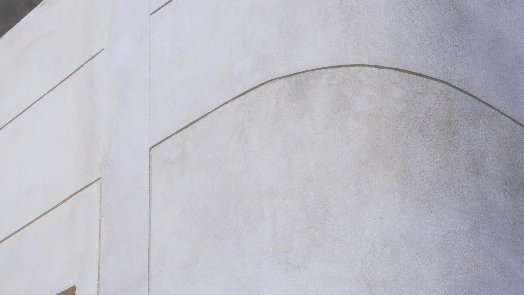 Background and texture of bare cement wall on the curve corner of external building wall with lines pattern on surface photo