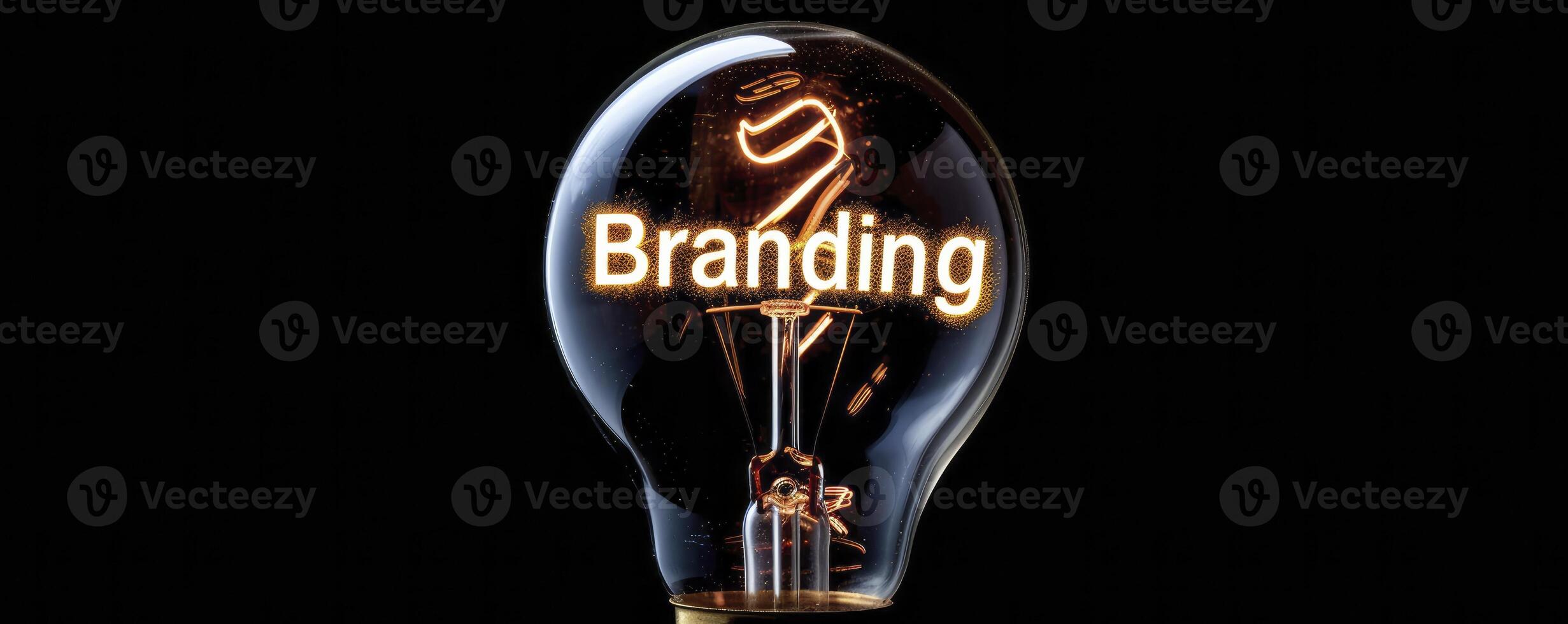 A light bulb with glowing wire forming the word Branding on a black background. photo