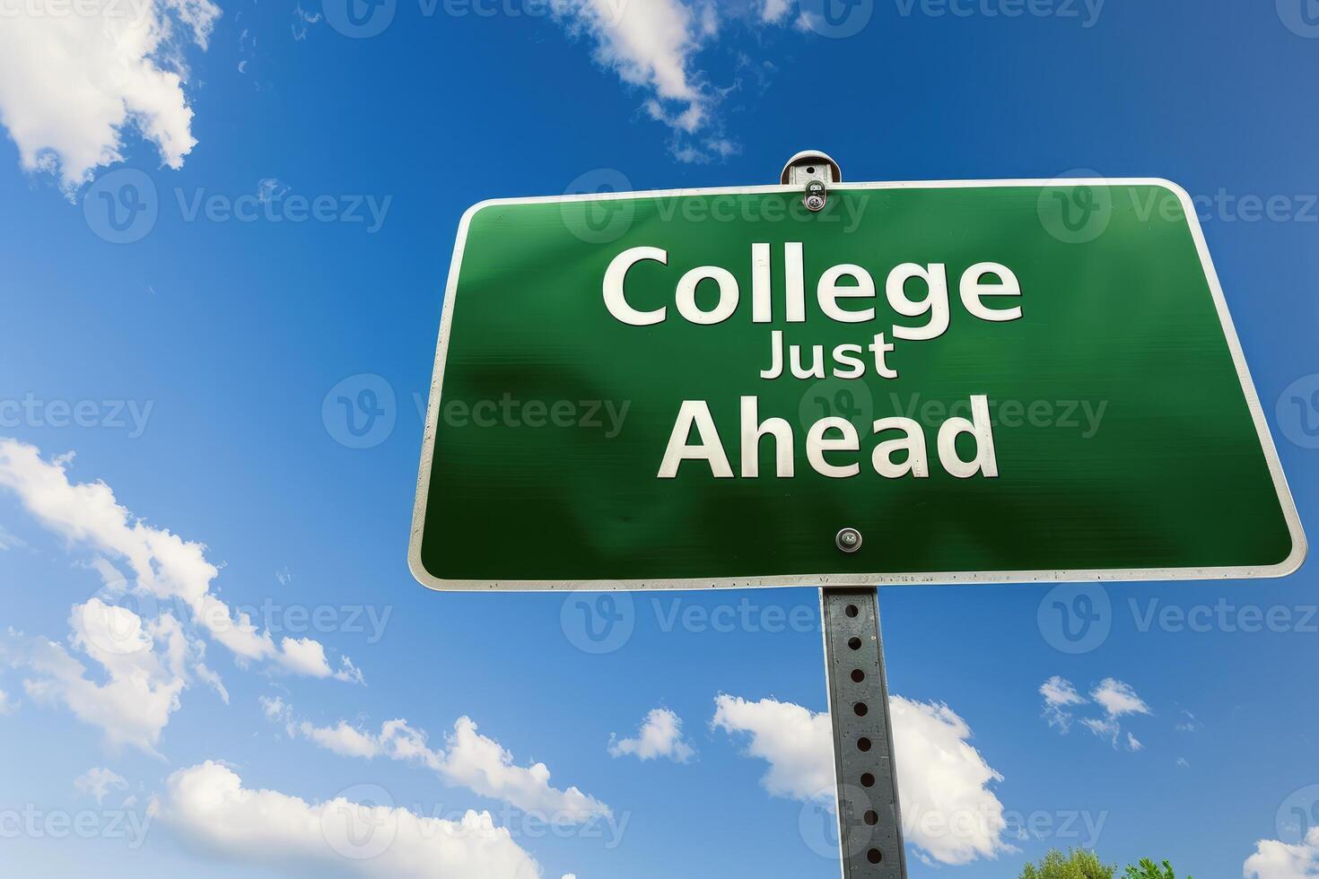 Green road with the words College Just Ahead against blue sky and clouds background. photo