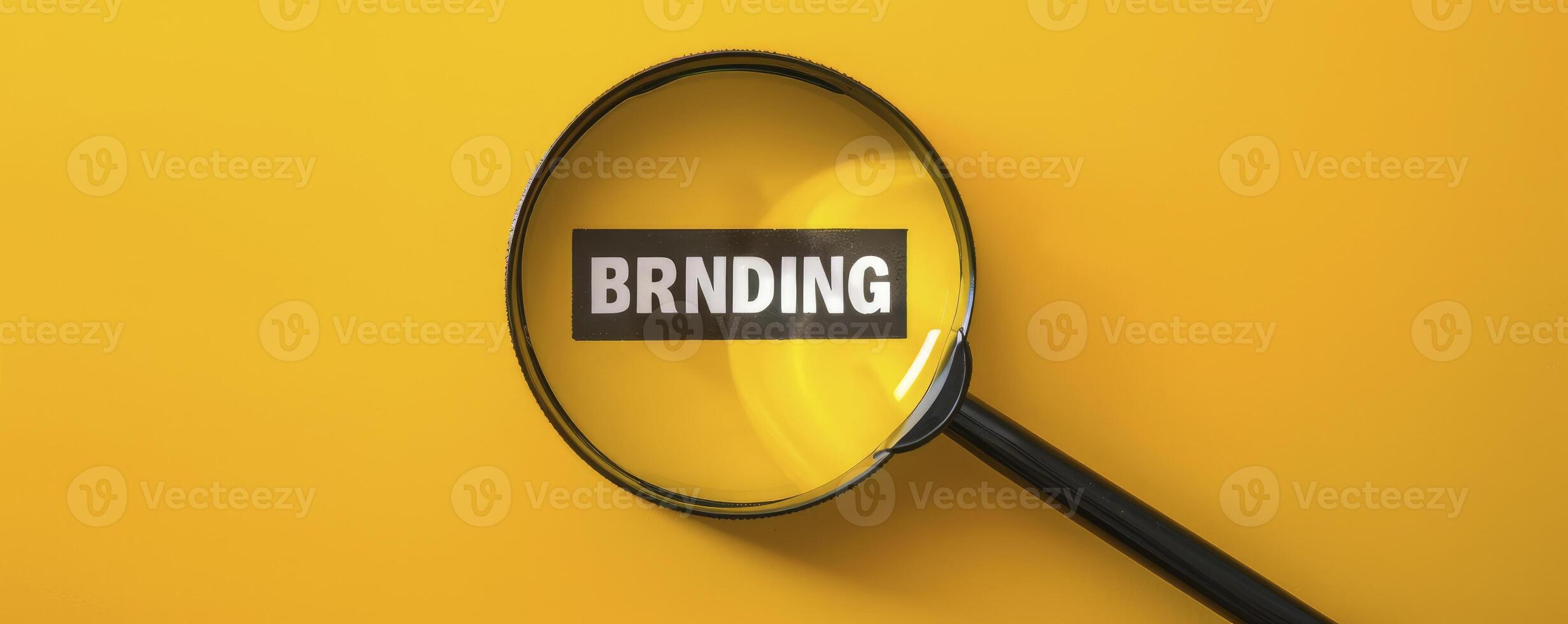 A magnifying glass over the word BRANDING on a yellow background photo