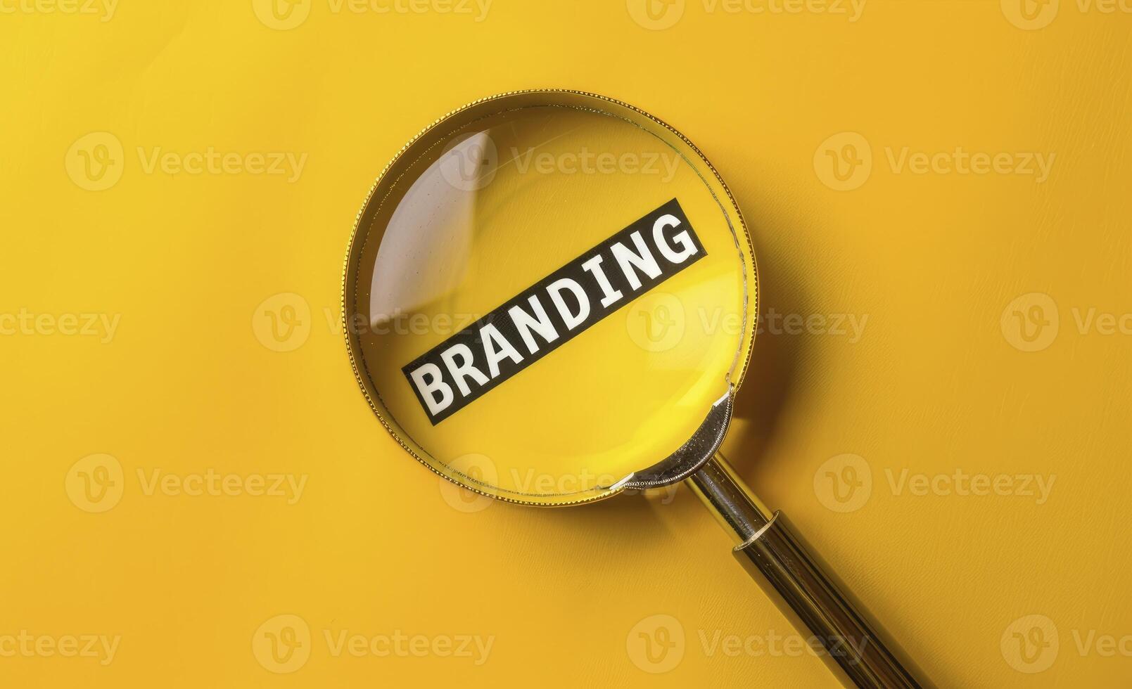 A magnifying glass over the word BRANDING on a yellow background photo