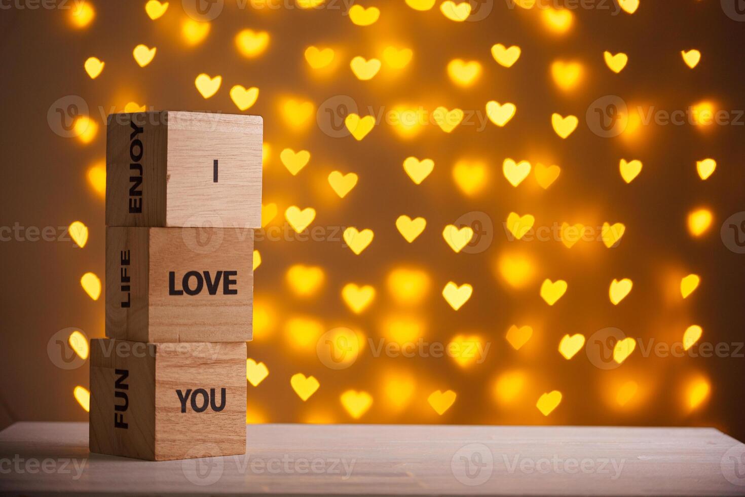 wooden cubes I Love You on a blurred background of hearts photo