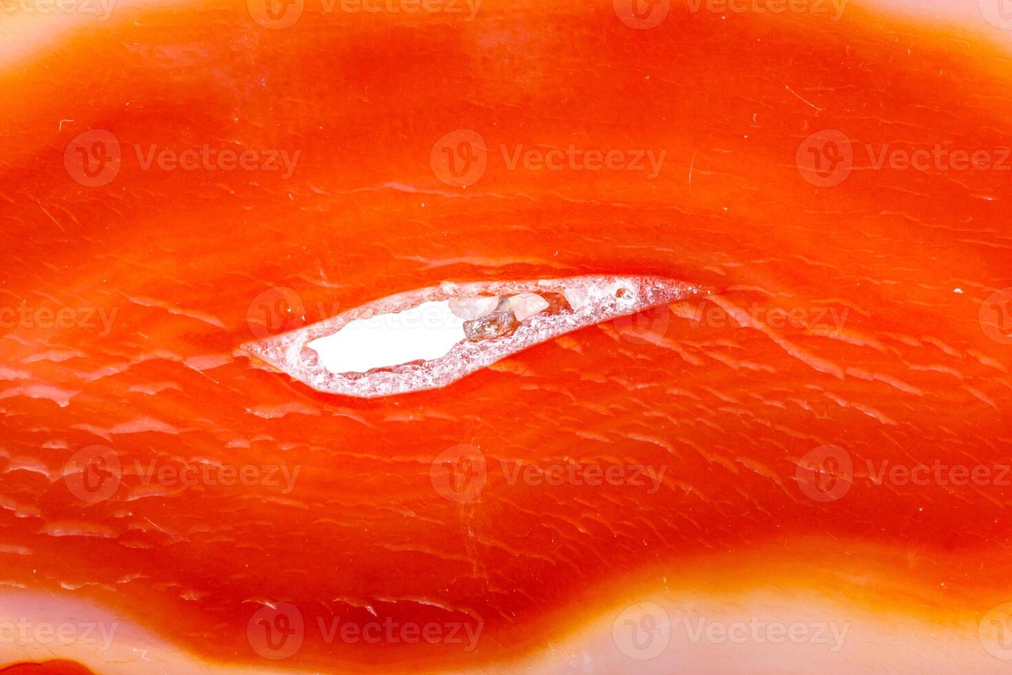 Macro mineral orange agate in crystals on white background photo