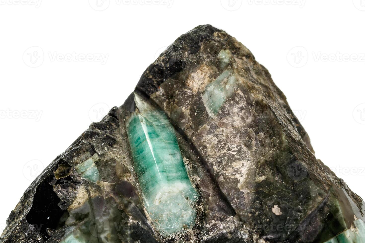 Macro emerald stone mineral in rock on white background photo