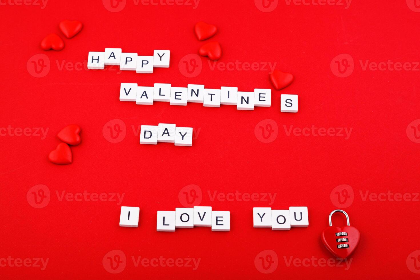 inscription Valentine's day and red hearts on a red background photo