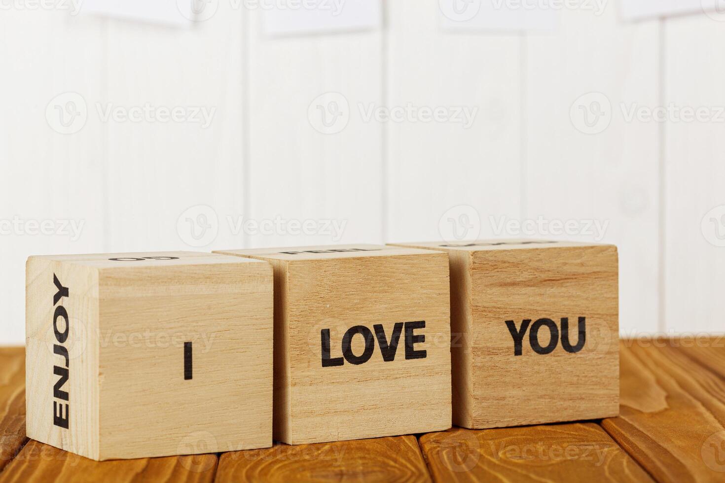 white pieces of paper on clothespins with a heart on a wooden background, a wooden inscription I love you photo