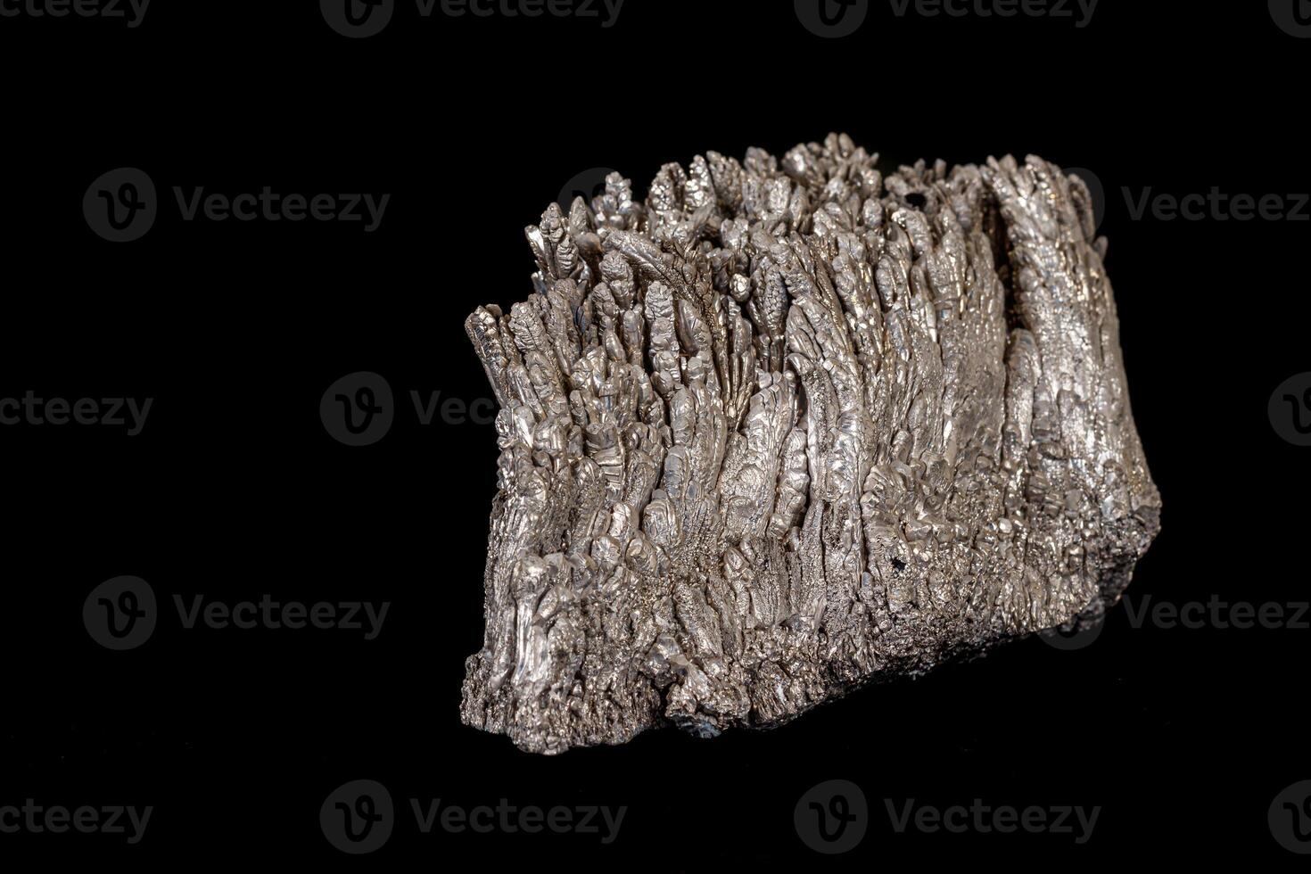 Macro of a stone Stibnite mineral on a black background photo