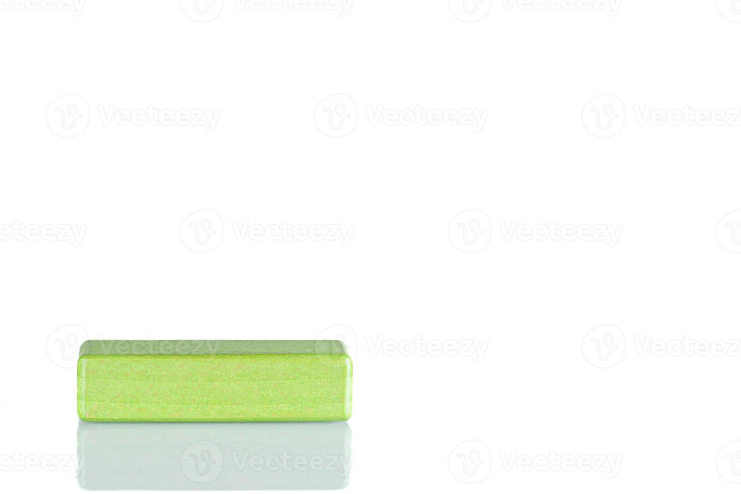 Wooden cube of green color on a white background photo