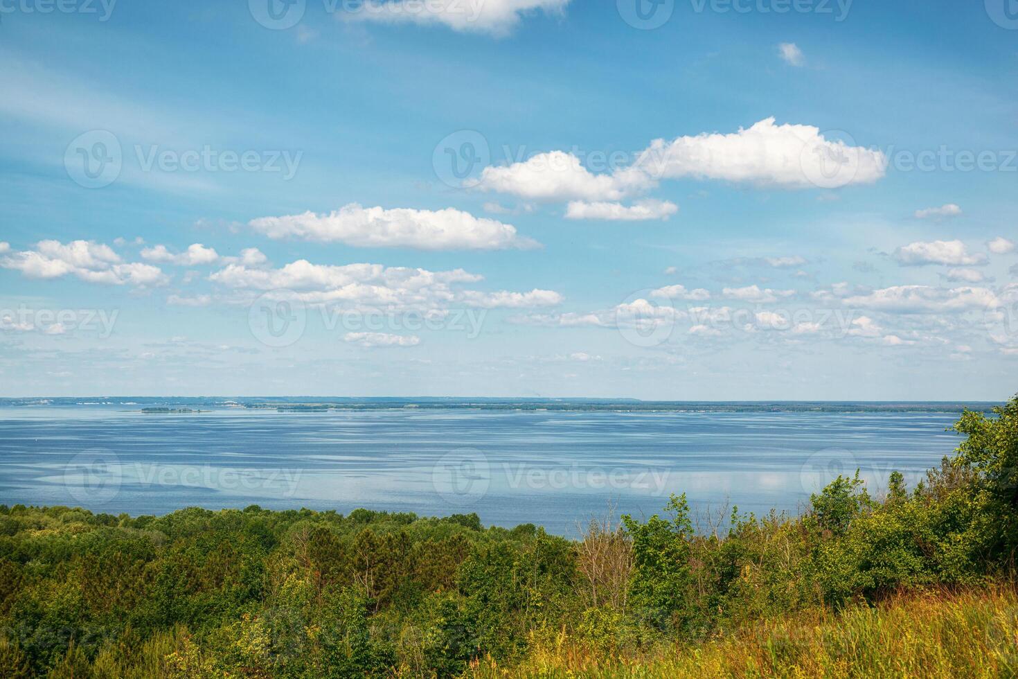 beautiful meadow on the hills with grass and flowers against the background of the sea and the sky photo