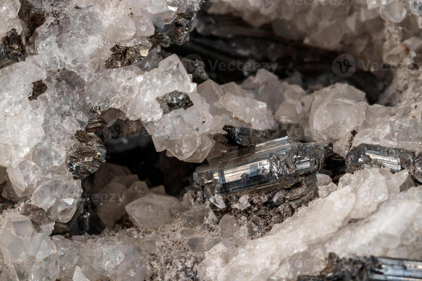 Macro mineral stone Stibnite quartz on a black background photo