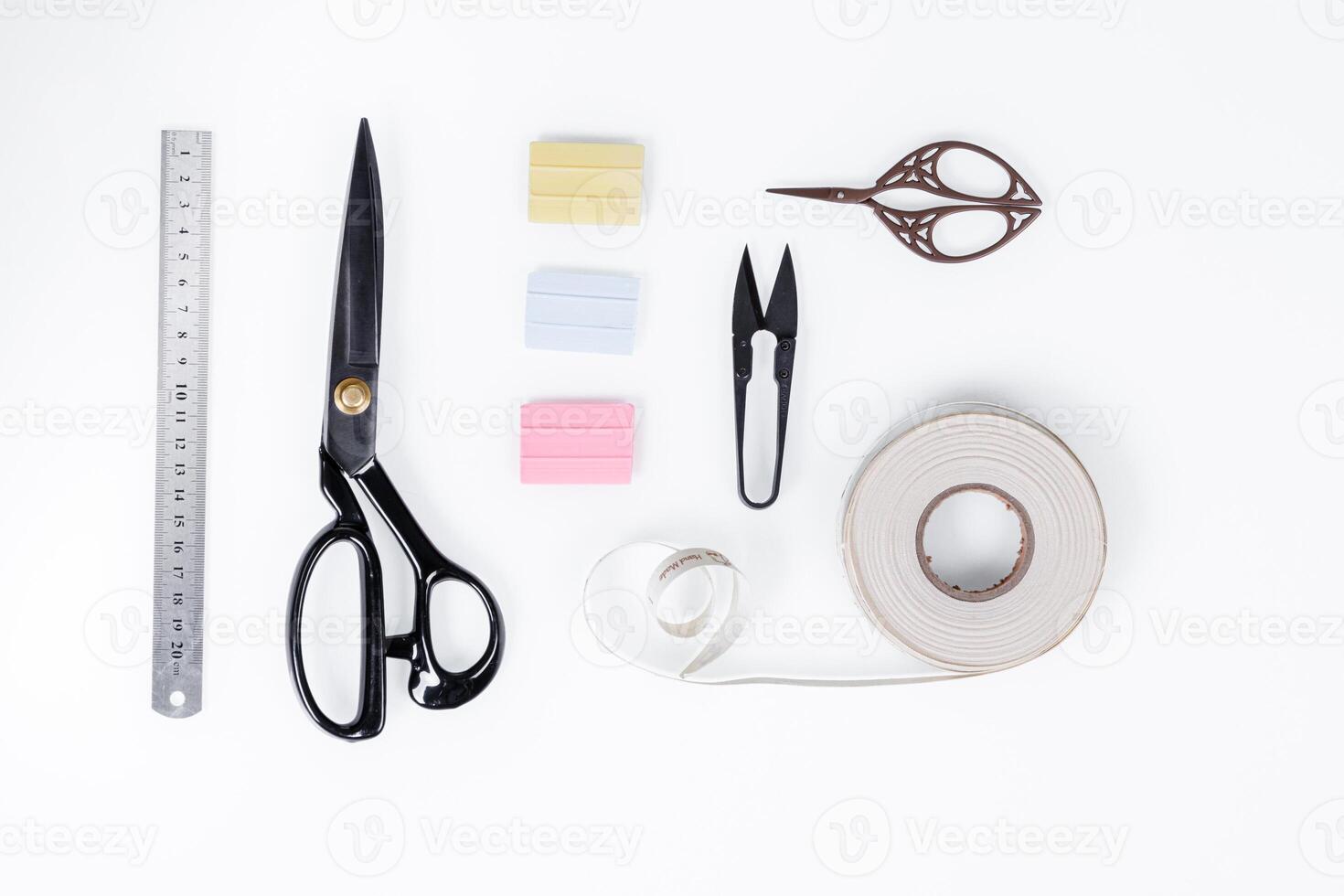 set of ruler, chalk, sticky tape, scissors for sewing on white background photo