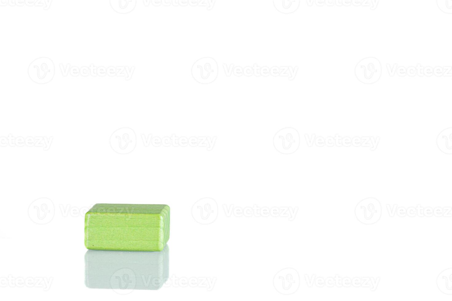 Wooden cube of green color on a white background photo