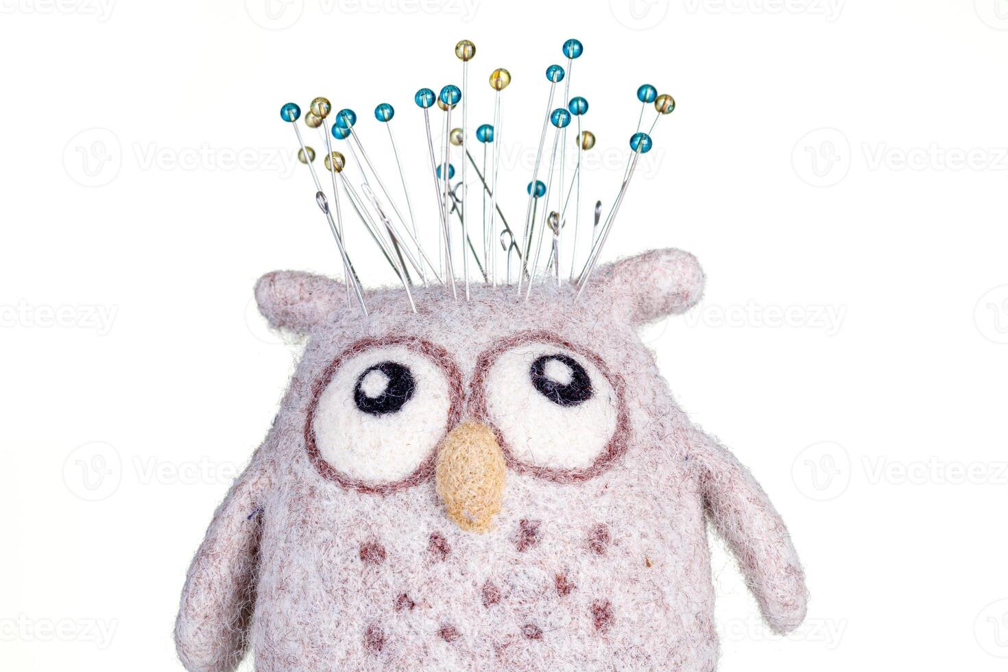 pincushion in the form of an owl on a white background photo