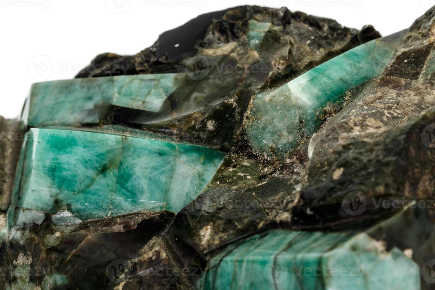 Macro emerald stone mineral in rock on white background photo