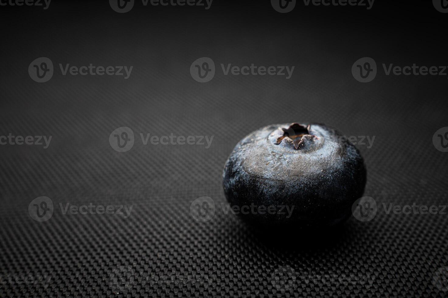 One blueberry black background. Very detailed macro shoot with copy space photo