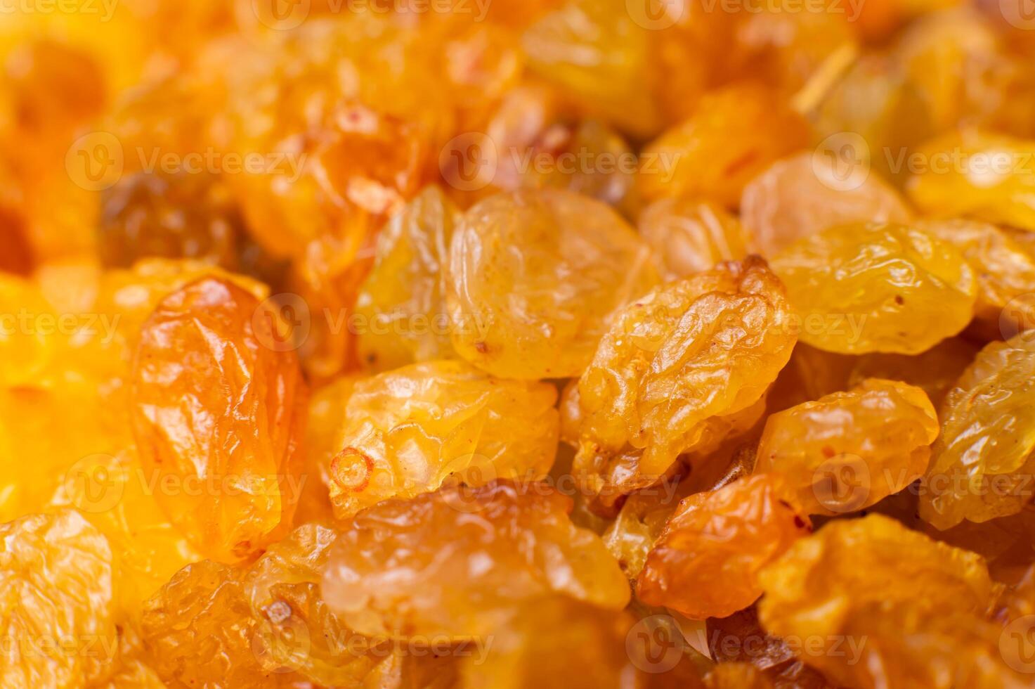 Background of a large number of dried yellow golden grapes. Raisin. Vegetarian diet photo