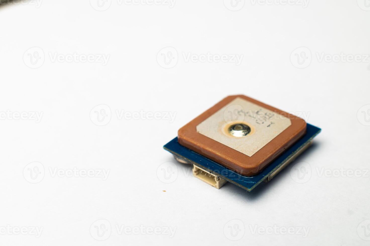 Waterproof GPS module with ceramic antenna on a white background in soft focus. Electronic components for hobby and assembly of FPV multicopters photo